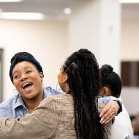 Girls of Color Summit previous event with two girls smiling and hugging